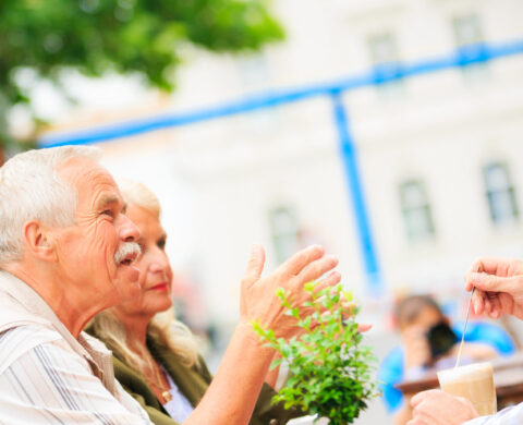 senior couple sitting in a cafe