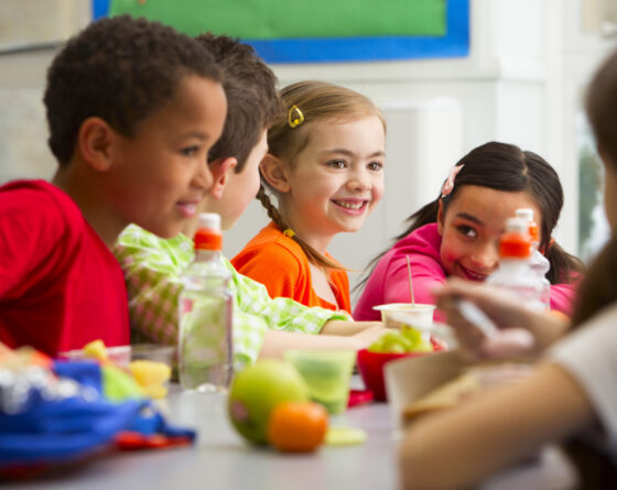 Young Students Enjoying Their Lunch At School