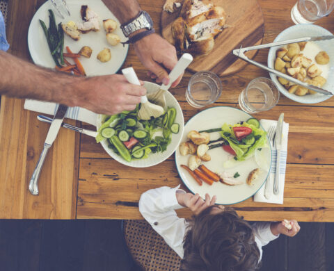 Father serving food to his son.