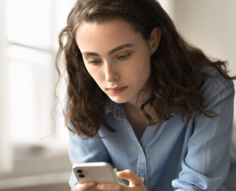 Serious Woman Lean At Workplace Desk Using Modern Gadget