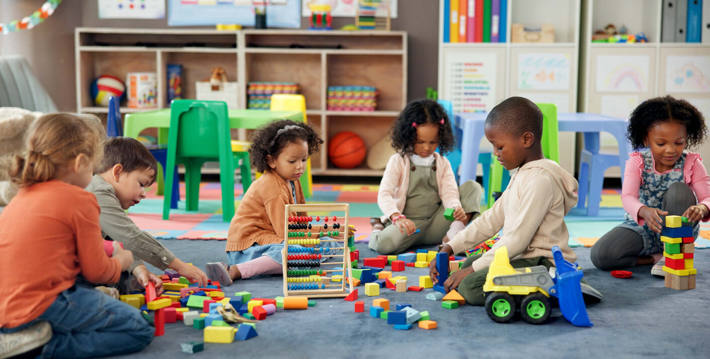 Kids, Students And Play With Blocks In Classroom For Learning, Problem Solving And Creative Activity. Children, Toys And Floor For Education Game, Puzzle Solution And Motor Growth In Kindergarden